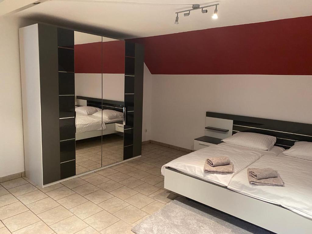 a bedroom with two beds and a mirror at Hotel Specht in Witten