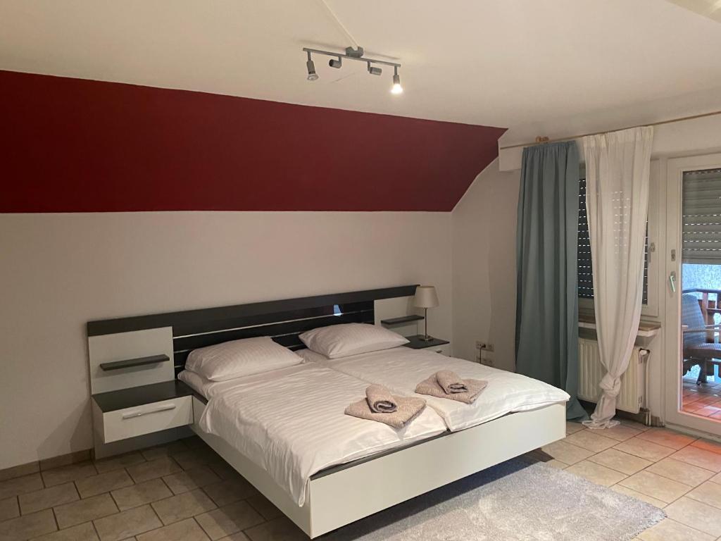 a bedroom with a large bed with white sheets at Hotel Specht in Witten
