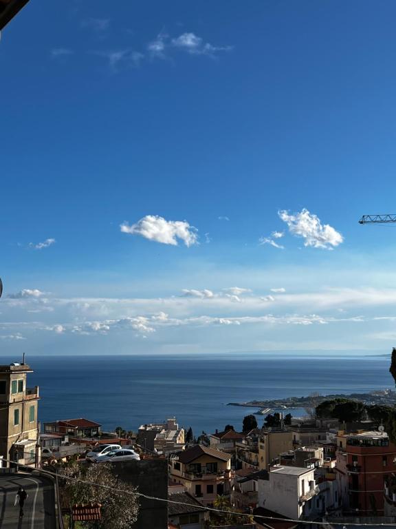 a view of the ocean from a city at Casetta Limonella in Taormina