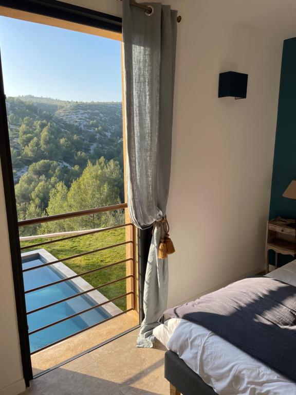 a bedroom with a large window with a view at AQUARIUS IN CASSIS, Chambres d'Hôtes in Cassis