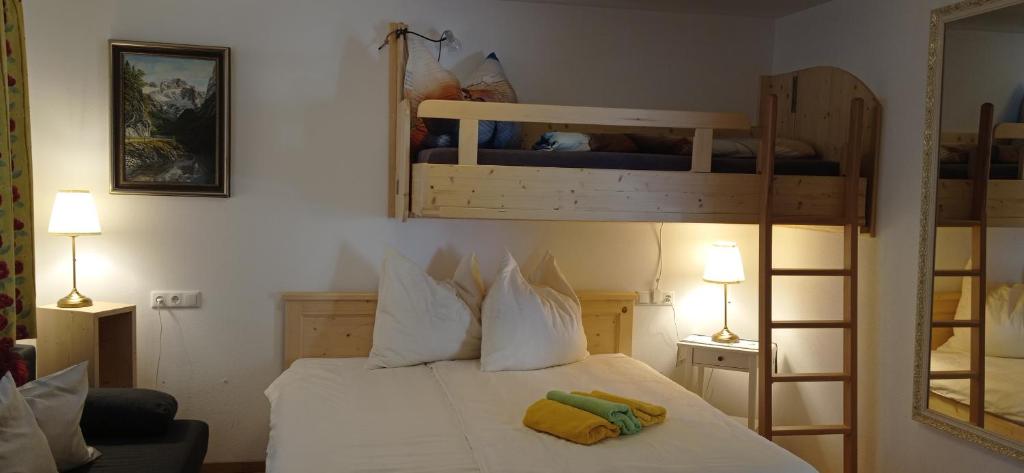a bedroom with a bed with two bunk beds at Landhaus Gerstgraser in Rauris