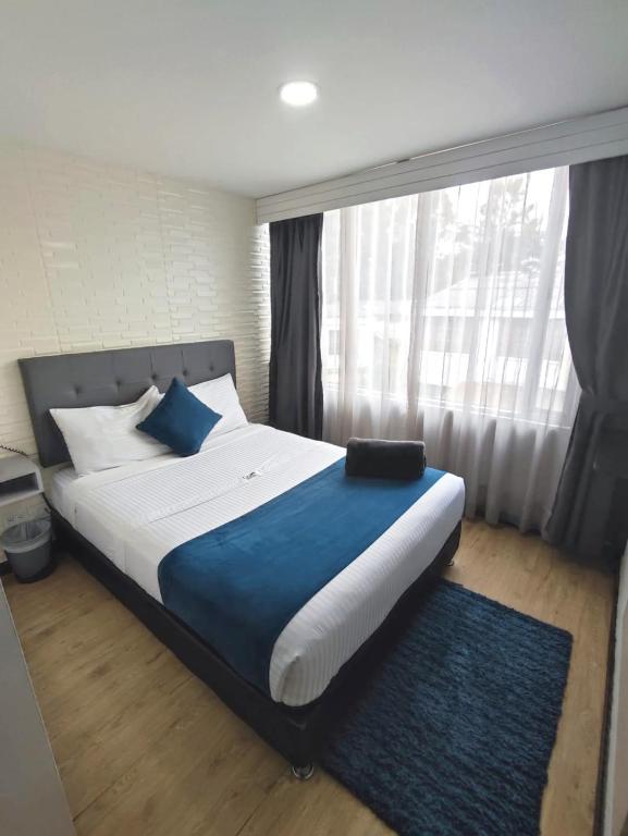 Postel nebo postele na pokoji v ubytování Hotel CGH Bogota Airport