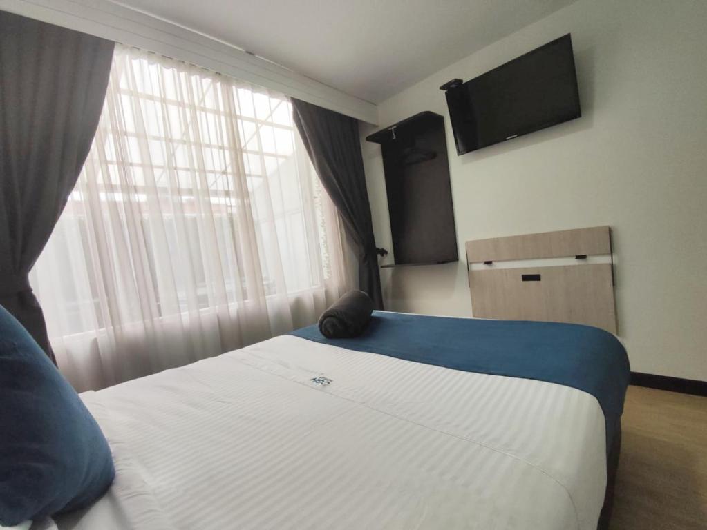 Postel nebo postele na pokoji v ubytování Hotel CGH Bogota Airport