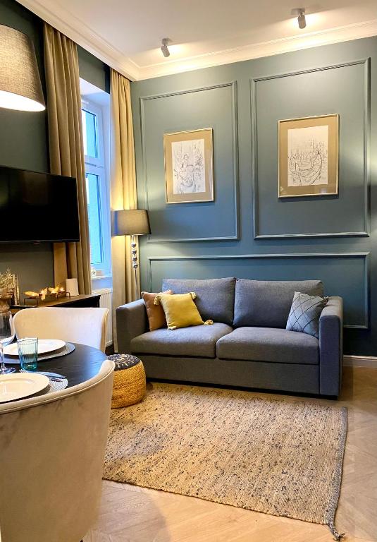 a living room with a couch and a table at Apartament Morska 5-4 in Darłowo
