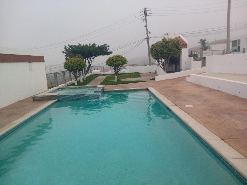 a swimming pool with blue water in a house at Monte Mar 7A in Divisadero