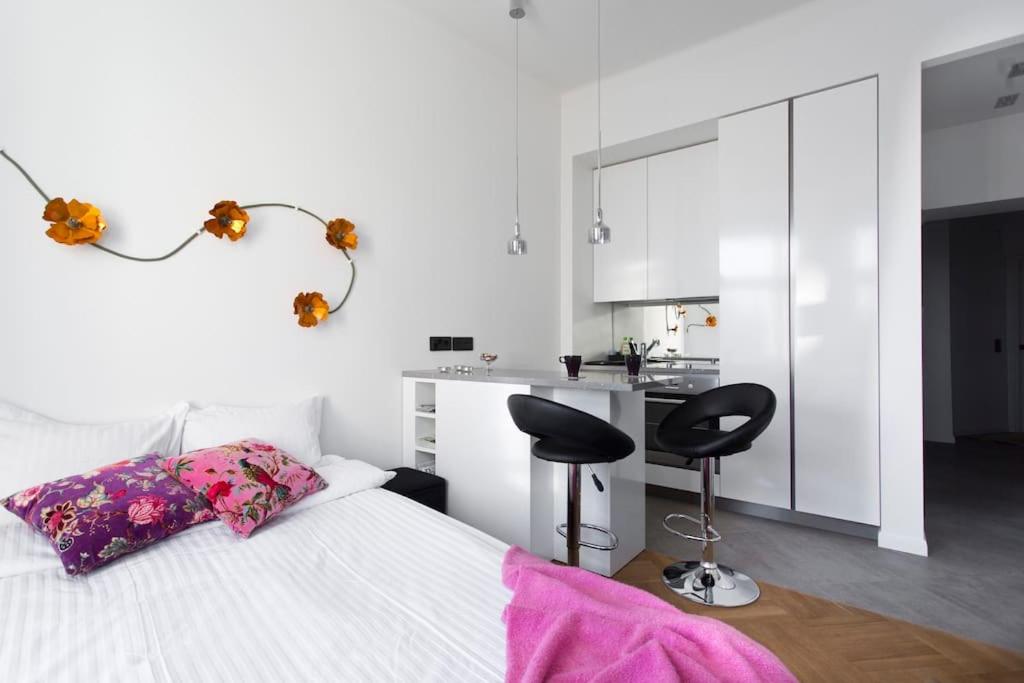 a bedroom with a bed with a desk and two chairs at Stylish studio in the centre in Helsinki