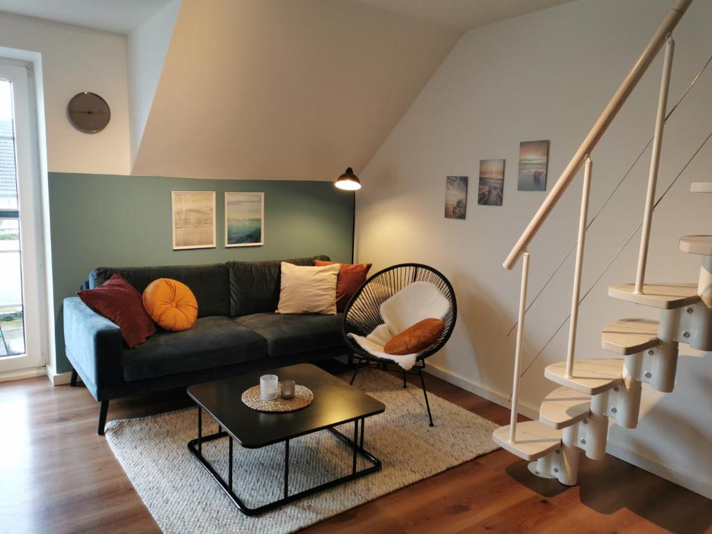 a living room with a couch and a table at Apartment Luise in Friedrichskoog