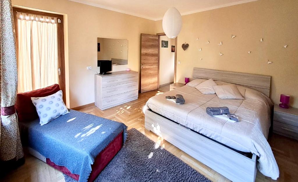 una camera con un letto e una sedia di Maison Lydie a Saint Vincent