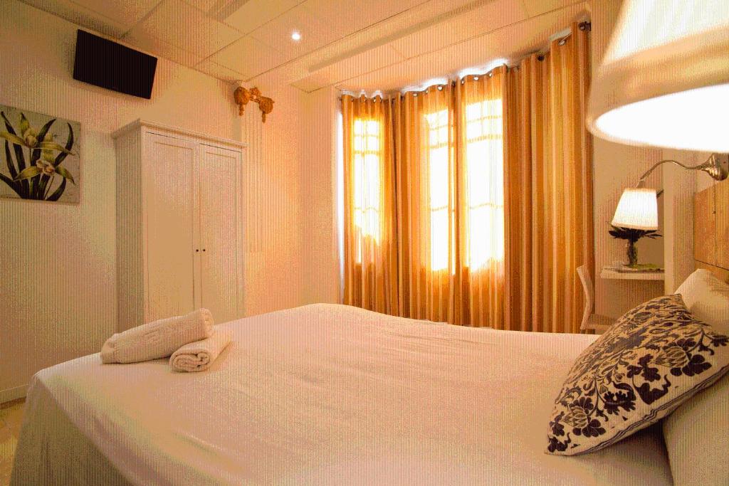 Posteľ alebo postele v izbe v ubytovaní Hostal Martinval