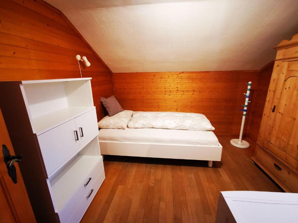 Cette petite chambre en bois comprend un lit. dans l'établissement Marmottin, à Lucerne
