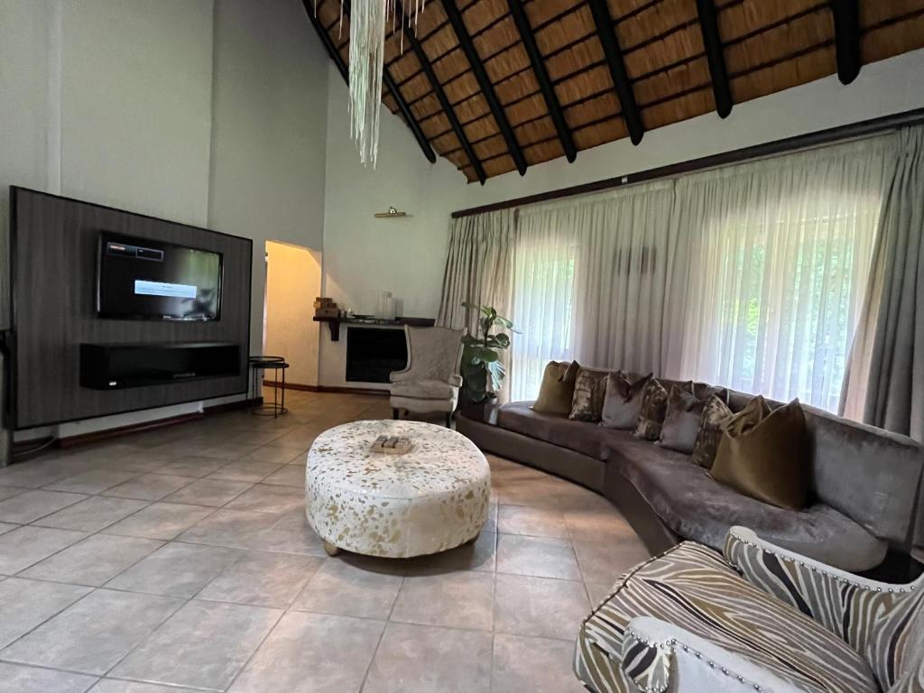 a living room with a couch and a coffee table at Rifumo Luxury Villa in Kruger Park Lodge in Hazyview