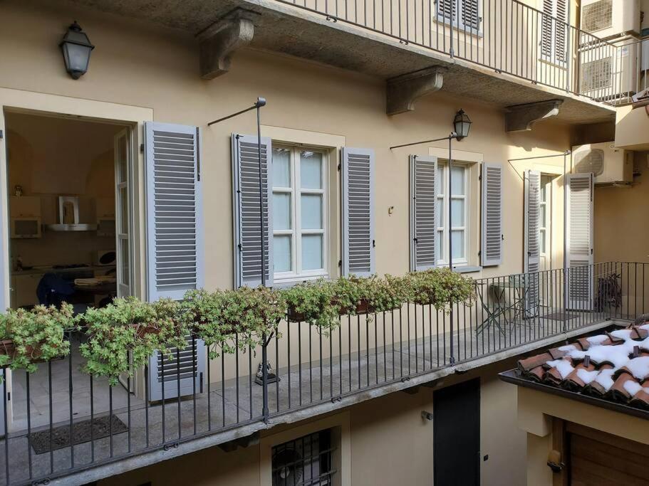 a balcony of a building with windows and plants at Gallina Apartment in Bra