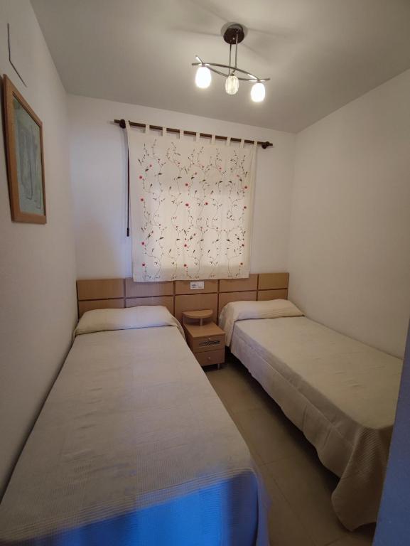Postel nebo postele na pokoji v ubytování Apartamento acogedor en Magic World, Torre la Sal