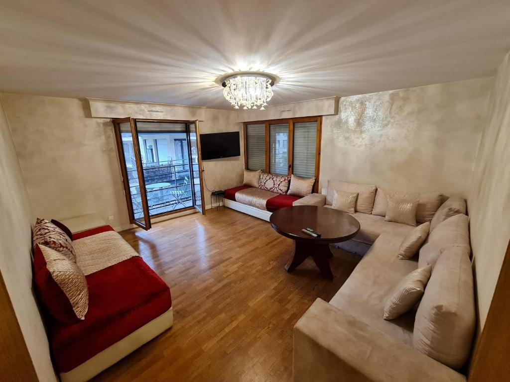 ein Wohnzimmer mit einem Sofa und einem Tisch in der Unterkunft appartement 2P 56 m2 centre Clichy-Levallois in Clichy