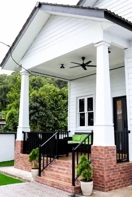 a pavilion on the front of a house at PREMIUM Tanjung Jara Cottage - with indoor pool in Dungun