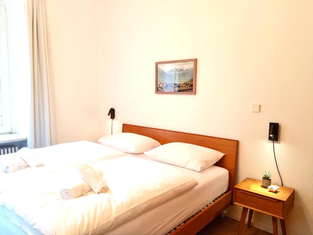 two twin beds in a room with a table at Apartment Emilie with parking historic city center in Merano