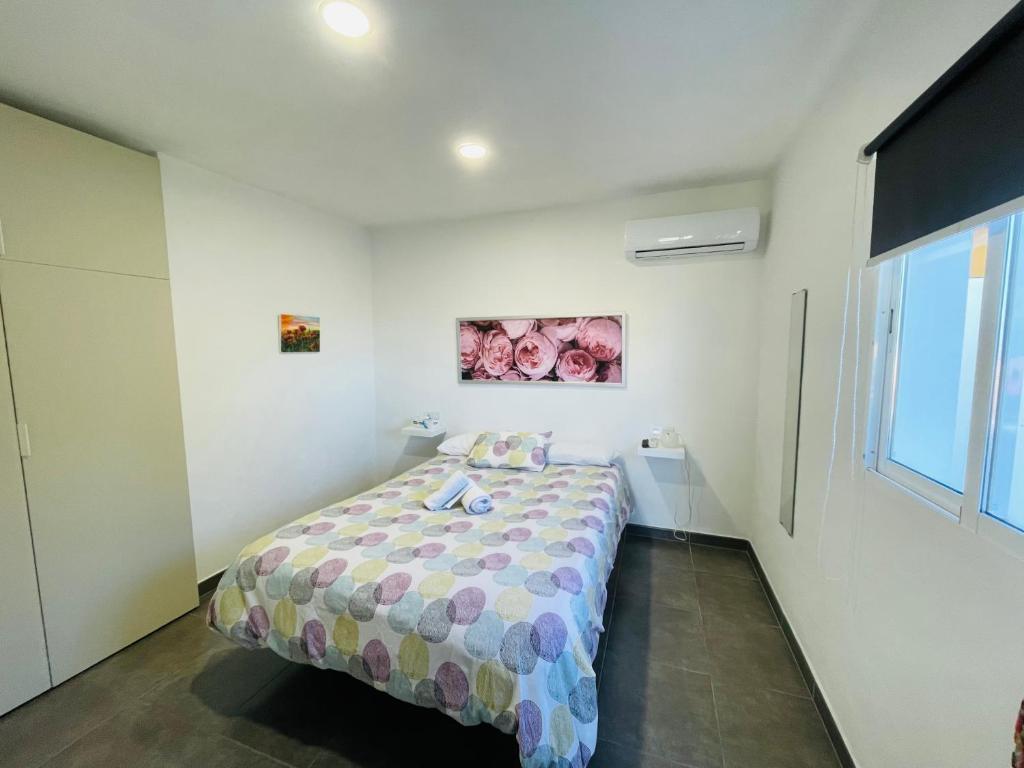 a bedroom with a bed in a white room at Vistas directas al volcán y piscina in El Paso