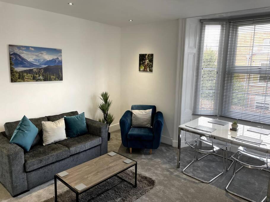 a living room with a couch and a table at Priestley Apartments Apt 1 in Nantwich