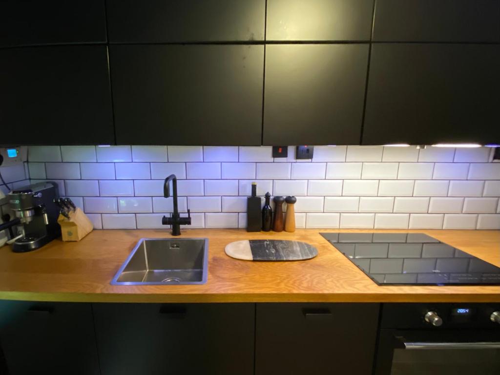 a kitchen with a sink and a counter top at Centrally Located London Apartment in London