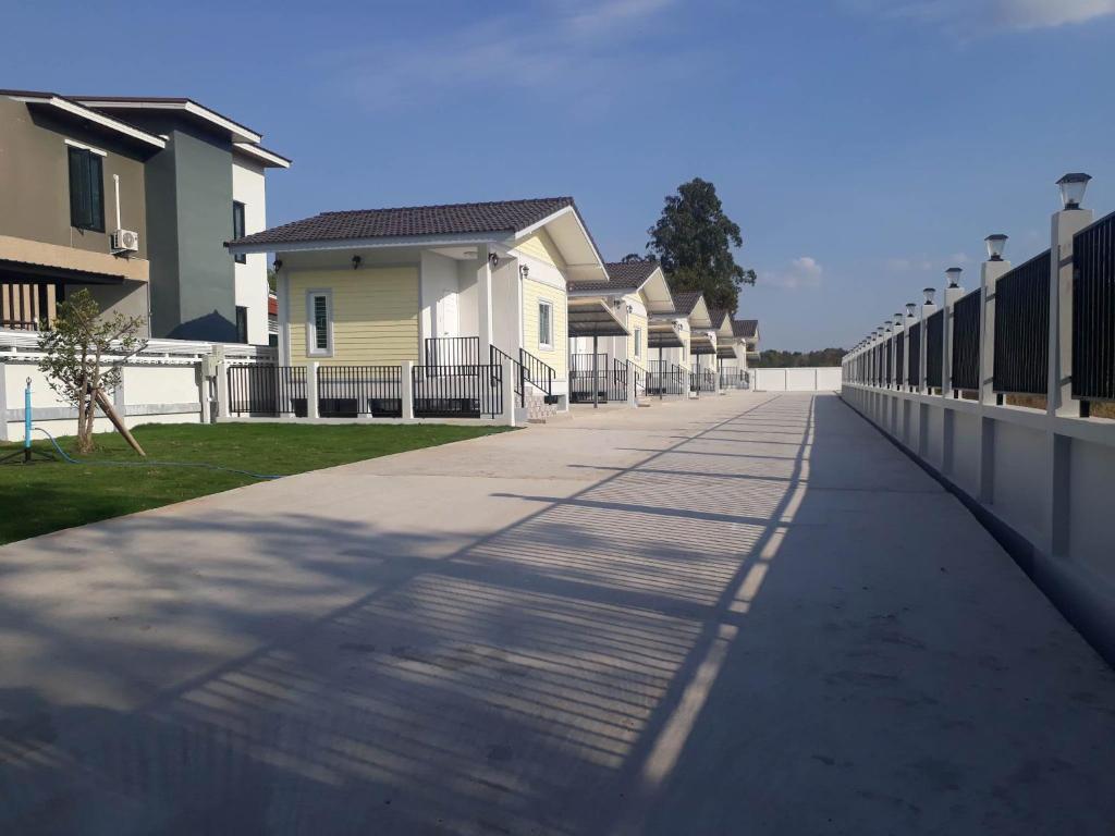 a walkway in front of a row of houses at PPN Garden Resort in Suwannaphum