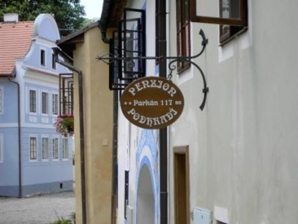 a sign for a restaurant on the side of a building at Penzion Podhradí in Český Krumlov