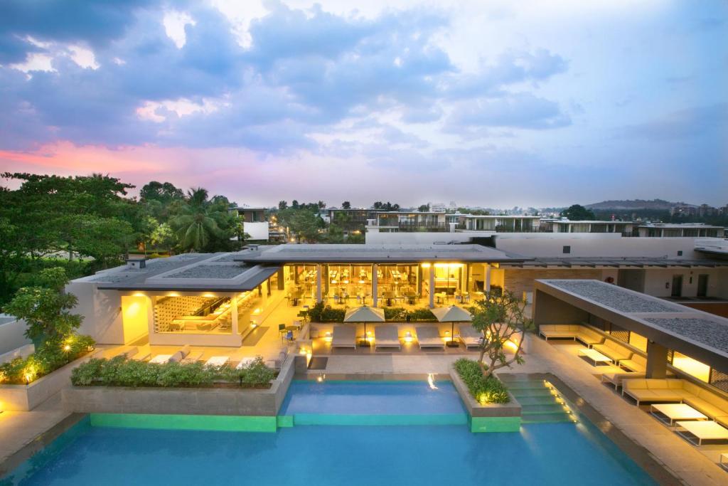 an aerial view of a building with a swimming pool at BLVD Club - Near BENGALURU AIRPORT in Bangalore