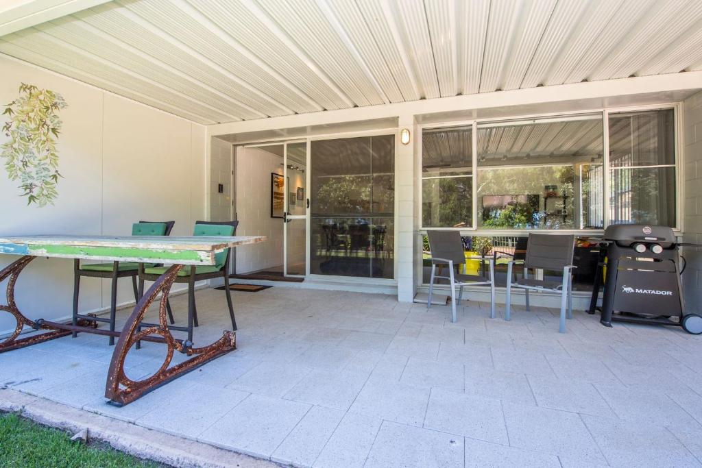 a patio with a ping pong table and chairs at Island View Apt 1 in Arcadia