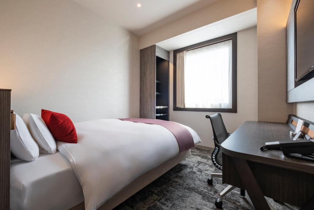 a hotel room with a bed and a desk at Hotel JAL City Haneda Tokyo in Tokyo