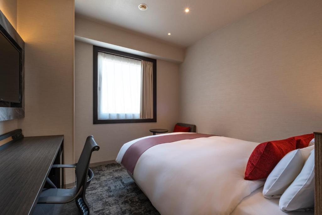 a hotel room with a large bed and a window at Hotel JAL City Haneda Tokyo in Tokyo