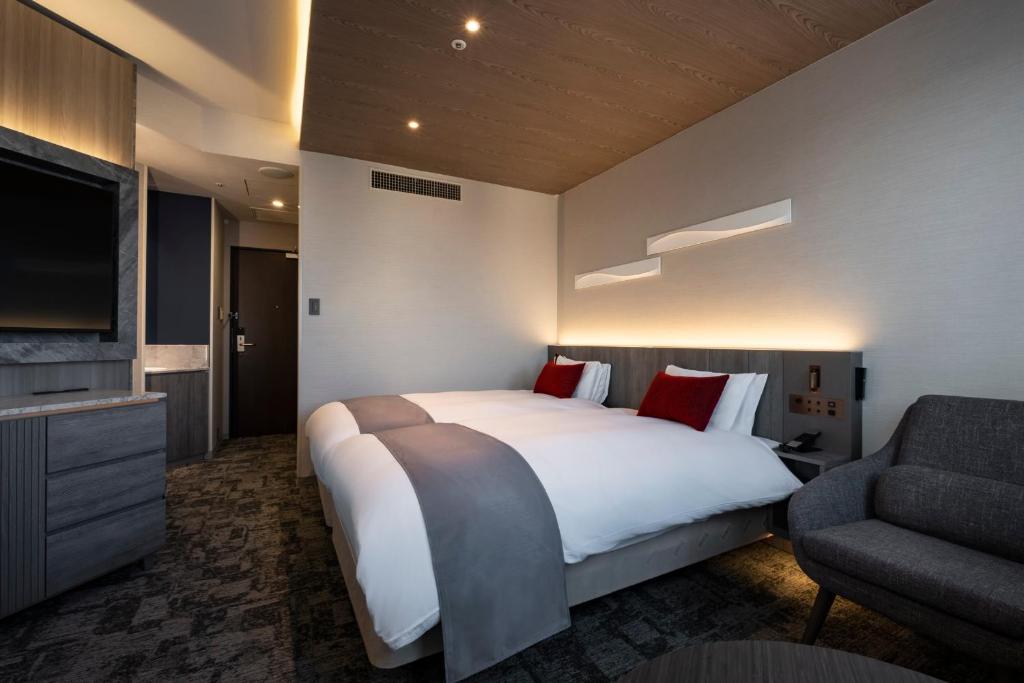 a hotel room with a large bed and a tv at Hotel JAL City Haneda Tokyo in Tokyo