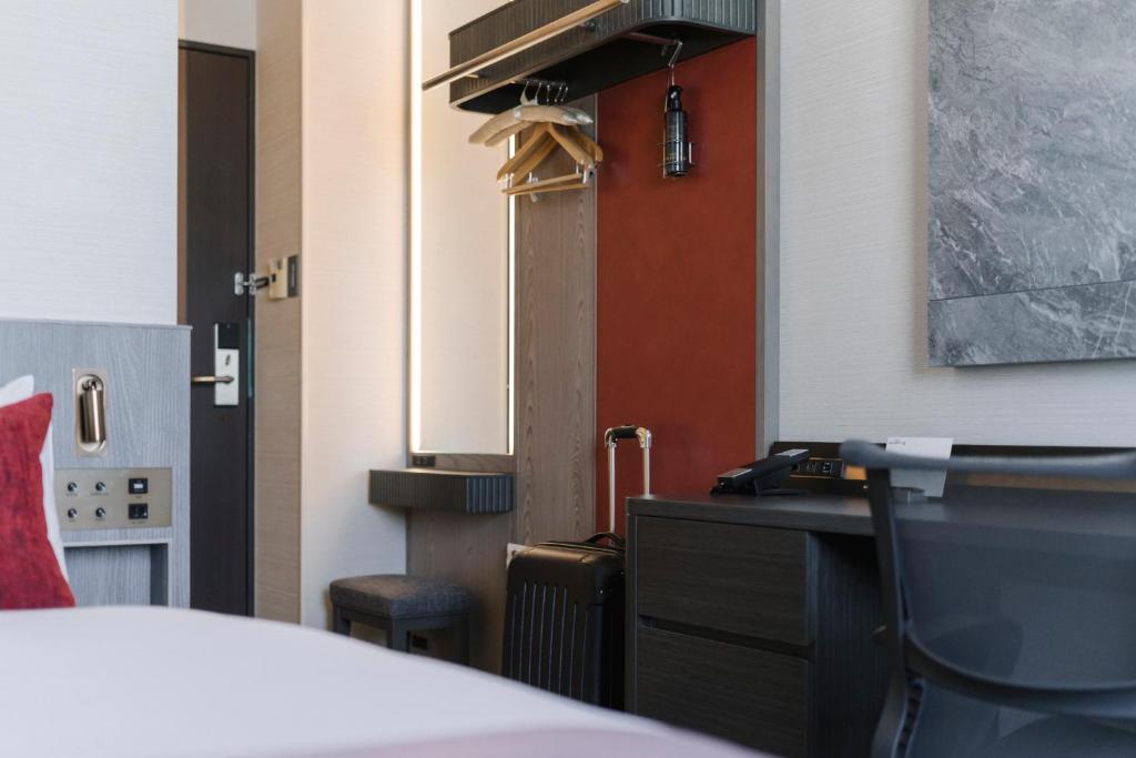 a room with a bed and a desk with a phone at Hotel JAL City Haneda Tokyo in Tokyo
