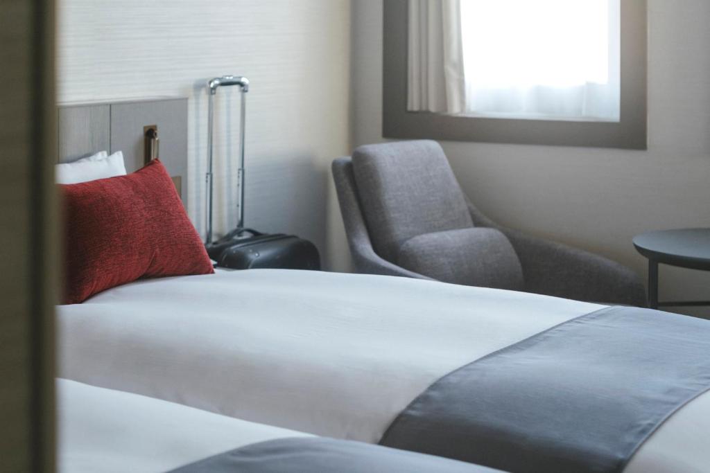 a hotel room with a bed and a chair at Hotel JAL City Haneda Tokyo in Tokyo