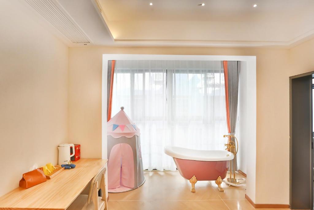 a bathroom with a tub and a large window at Flower Whisperer Homestay Tianmenshan Store free airport and station pick-up in Zhangjiajie