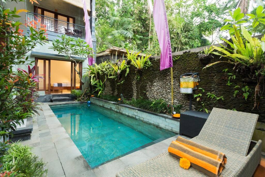 a house with a swimming pool in a yard at Villa Kubu Arya by Supala in Ubud