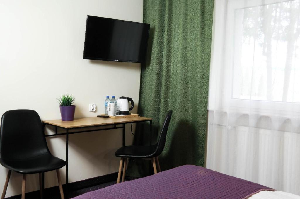 TV a/nebo společenská místnost v ubytování Hotel George