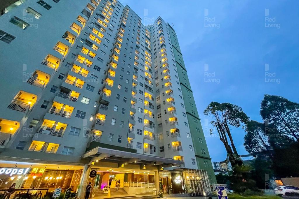 a large building with lights on in front of it at RedLiving Apartemen Parahyangan Residence - Anton Rooms in Bandung
