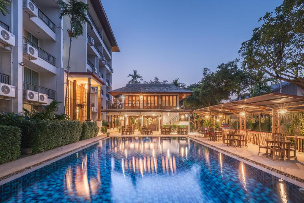 an image of a swimming pool in front of a building at Khammon Lanna Resort Chiang Mai in Chiang Mai