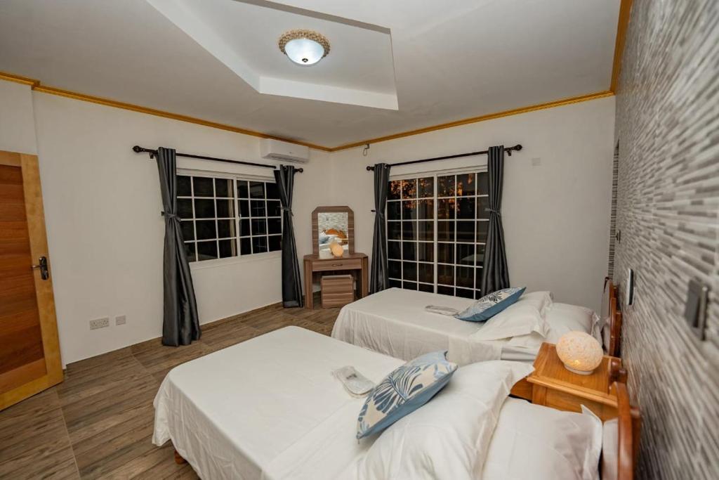 Postel nebo postele na pokoji v ubytování Paradise Breeze Apartment