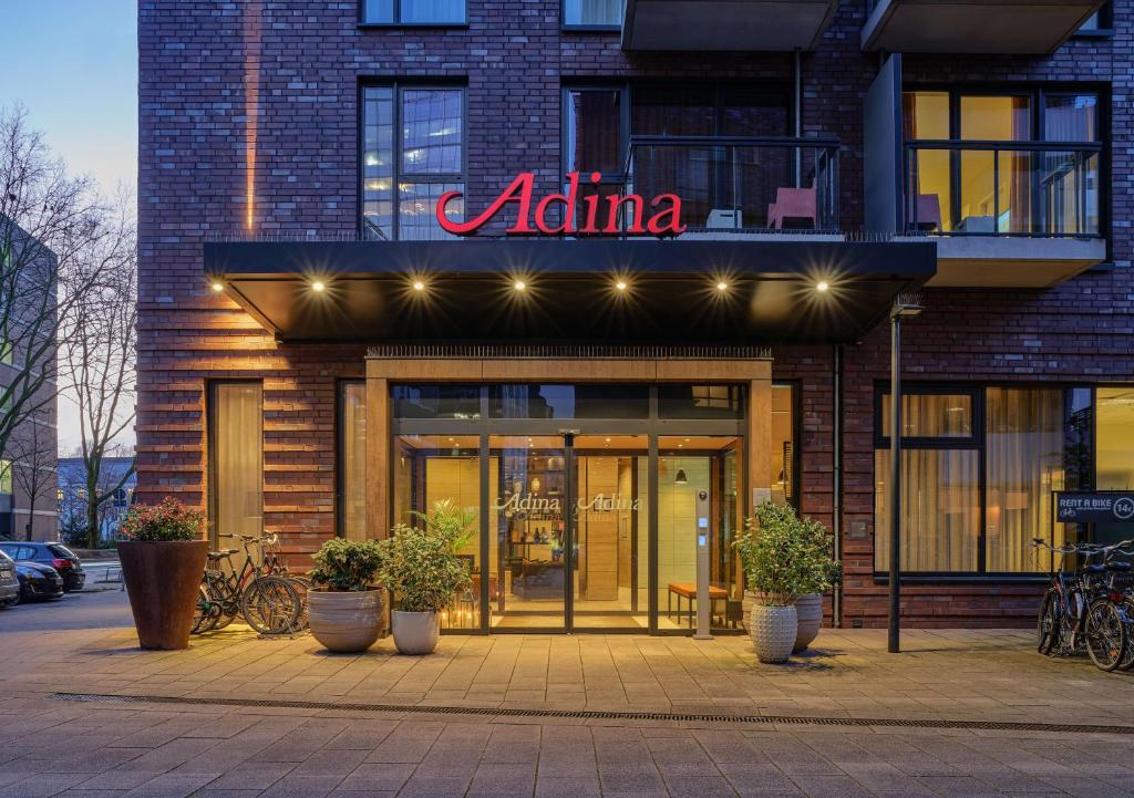 aania store with potted plants in front of a building at Adina Apartment Hotel Hamburg Michel in Hamburg