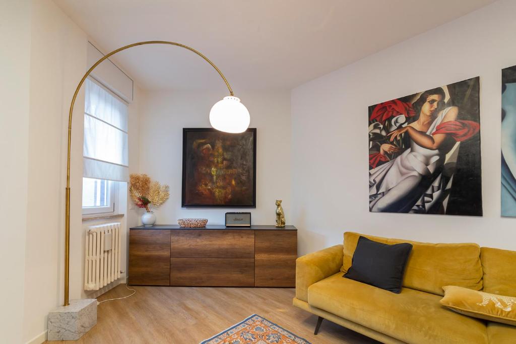 a living room with a yellow couch and a painting at [Luxury apartment near Navigli] - Anemoni 5 in Milan