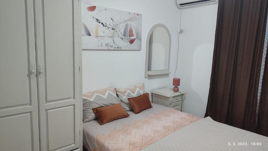a bedroom with a bed with two pillows on it at Pejovic Guest House in Sutomore