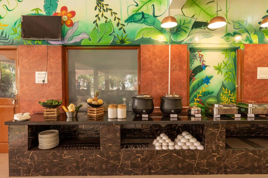 a kitchen with a counter with food on it at Nihita I Yoga, Spa, retreat in Dod Ballāpur