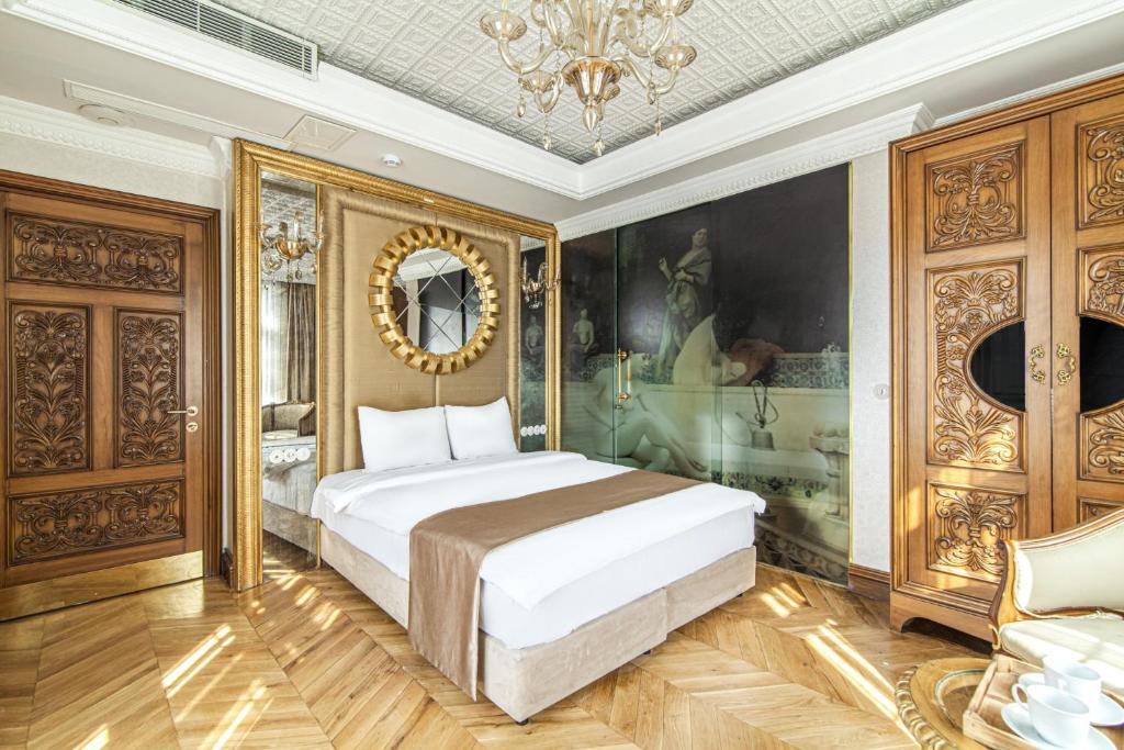 a bedroom with a bed and a painting on the wall at Studio Room in Historic Mansion in Beylerbeyi in Istanbul