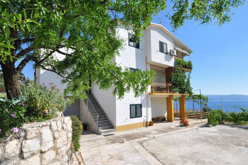 a villa with a view of the ocean at Apartments Jasna in Omiš