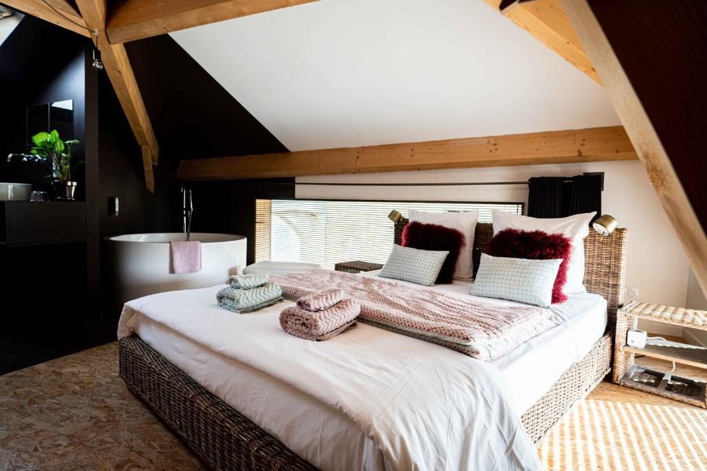 a bedroom with a large bed with pillows on it at La Métairie du Clos Saint Louis in Montréal