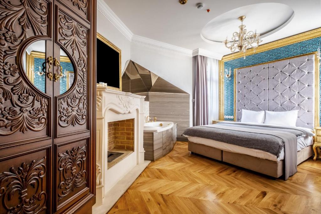 a bedroom with a king sized bed and a fireplace at Splendid Studio in Historic Mansion in Beylerbeyi in Istanbul