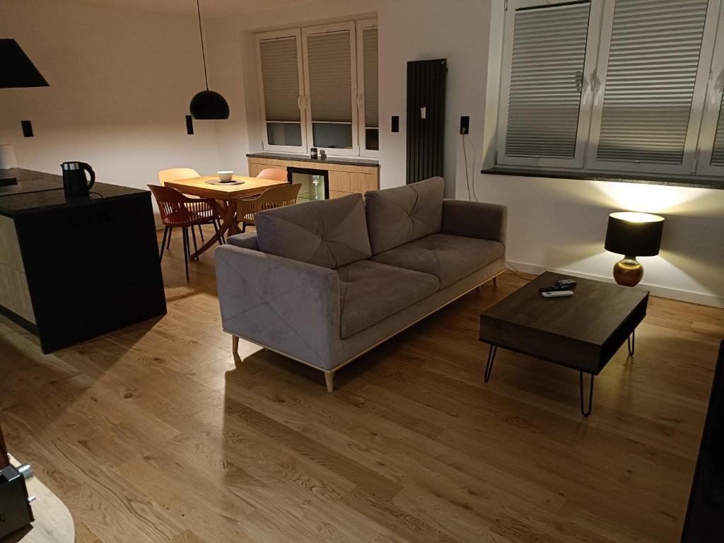 a living room with a couch and a table at Apartament 3 Maja 4 in Gorlice