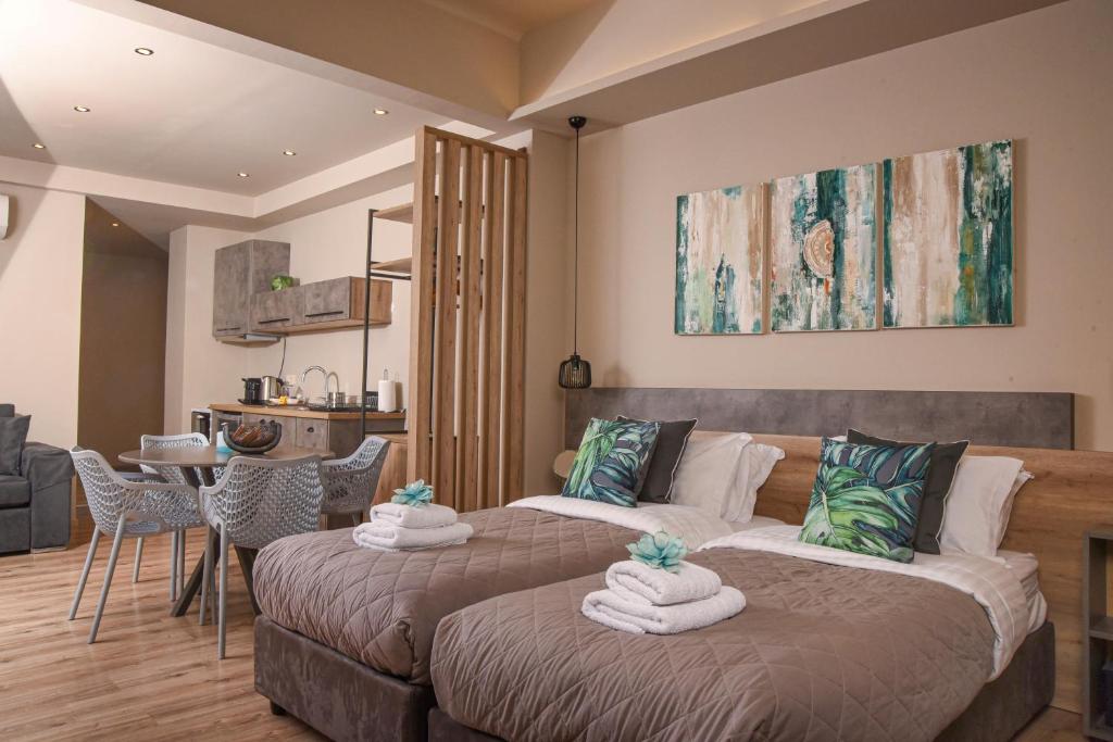 a bedroom with two beds with towels on them at Wisdom Residence Luxury Apartments at Plaka in Athens
