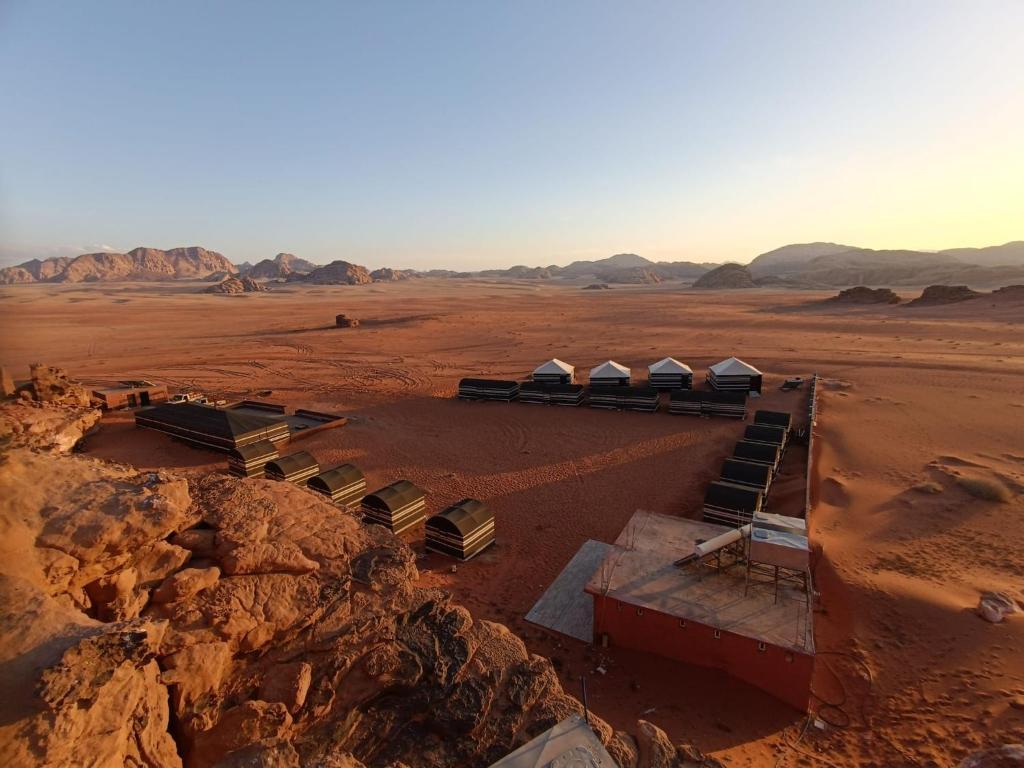 an aerial view of a desert with tents in the desert at Desert Dream Camp in Wadi Rum
