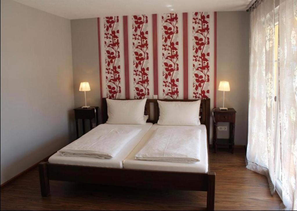 a bed in a room with a red and white wall at Apartments La Rosa in Rust
